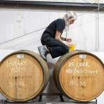 Katie Cochrane, head of production at Garden Path Fermentation, tops off a cider barrel on Wednesday, Jan. 7, 2026 in Burlington, Washington. (Olivia Vanni / The Herald)