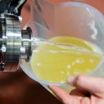Katie Cochrane fills up a cup with cider to top off other barrels at Garden Path Fermentation on Wednesday, Jan. 7, 2026 in Burlington, Washington. (Olivia Vanni / The Herald)