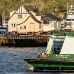 The Klahowya, an 87-vehicle Evergren State-class ferry, passes by two houses on a barge en route from Victoria, B.C., during an inter-island run in the San Juans in 2015. The Klahowya was retired in 2017. (Aaron Shepard / Contributed photo)