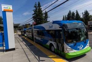 Two Swift Orange Line buses wait at the Edmonds College Transit Center on Friday, Aug. 1, 2025 in Lynnwood, Washington. (Olivia Vanni / The Herald)