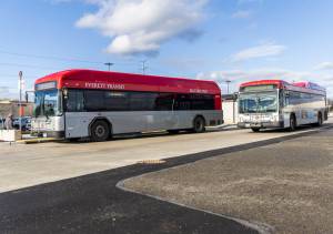 An Everett Transit bus drives away from Mall Station in December 2025 in Everett. (Olivia Vanni / The Herald)