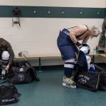 Lonnie Roughton, right, gets ready in the locker room before the Hackers game at Angel of the Winds Arena on Sunday, March 29, 2026 in Everett, Washington. (Olivia Vanni / The Herald)