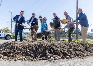Community leaders and people involved in the Poplar Way Bridge project break ground during an event on Wednesday, April 8, 2026, in Lynnwood, Washington. (Olivia Vanni / The Herald)