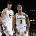 Elliot Cadeau (3) celebrates as Aday Mara (15) of the Michigan Wolverines looks on during the first half of a game against the UConn Huskies in the National Championship of the 2026 NCAA Men's Basketball Tournament at Lucas Oil Stadium on Monday in Indianapolis, Indiana. (Michael Reaves / Getty Images / The Athletic)
