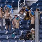 A group of kids yell and wave their shirts after the AquaSox score their first run of the game during the fourth inning against the Tri-City Dust Devils on Tuesday, April 7, 2026 in Everett, Washington. (Olivia Vanni / The Herald)