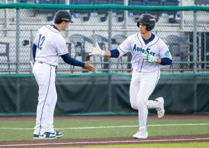 Luke Stevenson of the Everett AquaSox high-fives manager Ryan Scott after hitting his first High-A home run against the Tri-City Dust Devils on Thursday, April 9, 2026 at Everett Memorial Stadium. (Photo courtesy of Shari Sommerfeld / Everett AquaSox)