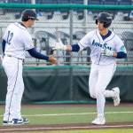 Luke Stevenson of the Everett AquaSox high-fives manager Ryan Scott after hitting his first High-A home run against the Tri-City Dust Devils on Thursday at Everett Memorial Stadium. (Photo courtesy of Shari Sommerfeld / Everett AquaSox)