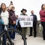 A person holds a sign that says, Its been so long. Come see us soon! - Mukilteo, during the ribbon cutting for the new Edgewater Bridge on Monday, April 27, 2026, in Everett, Washington. (Olivia Vanni / The Herald)