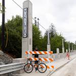 A cyclists waits on the Everett side of the new Edgewater Bridge on Monday, April 27, 2026, in Everett, Washington. (Olivia Vanni / The Herald)