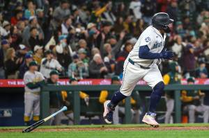 Josh Naylor (12) of the Seattle Mariners hits a walk-off RBI single during the ninth inning against the Athletics at T-Mobile Park on Wednesday, April 22, 2026, in Seattle. (Jack Compton / Getty Images / Tribune News Services)