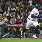 Josh Naylor (12) of the Seattle Mariners hits a walk-off RBI single during the ninth inning against the Athletics at T-Mobile Park on Wednesday, in Seattle. (Jack Compton / Getty Images / Tribune News Services)