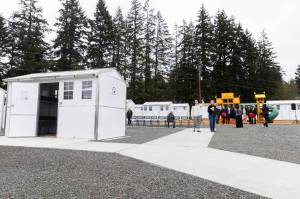 People explore the new Pallet shelter location after a ribbon cutting to celebrate the opening on Monday, April 27, 2026, in Everett, Washington. (Olivia Vanni / The Herald)