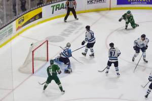 Silvertips forward Julius Miettinen (top right) fires a shot on Vees goaltender Andrew Reyelts during Everetts 4-1 win against Penticton in Game 1 of the WHL Western Conference Finals at Angel of the Winds Arena on April 23, 2026. (Joe Pohoryles / The Herald)