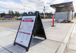 A sign at Everett Transit’s Mall Station advertises free shuttles to Walmart on Monday, Dec. 22, 2025 in Everett, Washington. (Olivia Vanni / The Herald)