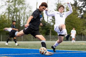 Shorewoods Tajidin Babayev clears the ball against Glacier Peaks Tyler Larsen during the game on Tuesday, April 28, 2026 in Shoreline, Washington. (Olivia Vanni / The Herald)