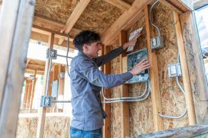 Tyson Williams talks about his electrical work during a showcase for Regional Apprenticeship Pathways students on Thursday, April 30, 2026 in Marysville, Washington. (Olivia Vanni / The Herald)
