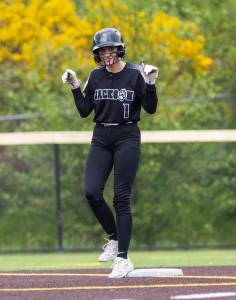 Jackson’s Mia Ediger puts her arms up after making it to second base during the 4A District 1 game against Lake Stevens on Friday, May 16, 2025 in Everett, Washington. (Olivia Vanni / The Herald)