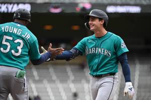 Cole Young (2) of the Seattle Mariners celebrates with first base coach Eric Young Jr. (53) after hitting a go-ahead two-run RBI single against the Minnesota Twins during the ninth inning of the game at Target Field on Wednesday, April 29, 2026, in Minneapolis. (Stephen Maturen / Getty Images / Tribune News Services)