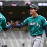Cole Young (2) of the Seattle Mariners celebrates with first base coach Eric Young Jr. (53) after hitting a go-ahead two-run RBI single against the Minnesota Twins during the ninth inning of the game at Target Field on Wednesday in Minneapolis. (Stephen Maturen / Getty Images / Tribune News Services)