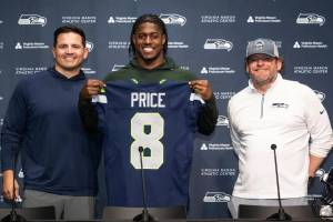 Seahawks first-round pick Jadarian Price holds up his No. 8 jersey during an introductory press conference along with coach Mike Macdonald and general manager John Schneider at the Virginia Mason Athletic Center in Renton, Washington on Thursday, April 30, 2026. (Photo courtesy of the Seattle Seahawks)