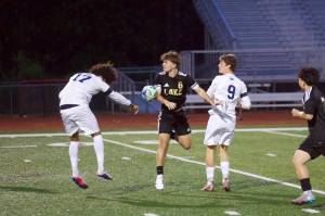 Glacier Peak senior Joziah Coppin (left) heads the ball into Lake Stevens junior Mac Wilson during the Grizzlies 3-1 loss to the Vikings at Lake Stevens High School on May 1, 2026. (Joe Pohoryles / The Herald)