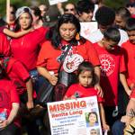 Loni Long holds a missing persons sign for her sister, Benita Long, as she stands with more than 100 people gathered for a rally to honor missing and murdered Indigenous people on Tuesday, May 5, 2026, in Tulalip, Washington. (Olivia Vanni / The Herald)