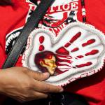 An MMIW beaded pendant necklace hangs around the neck of a rally attendee in honor of missing and murdered Indigenous people on Tuesday, May 5, 2026, in Tulalip, Washington. (Olivia Vanni / The Herald)