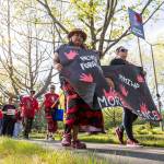 Cynthia Leon-Ortiz and Shawnee Sheldon walk with a banner during a march in honor of missing and murdered Indigenous people on Tuesday, May 5, 2026, in Tulalip, Washington. (Olivia Vanni / The Herald)