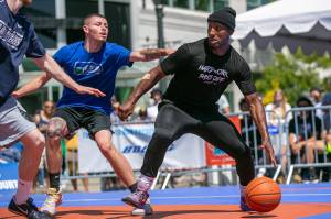 Kiante Woods of MUV Elite (right) dribbles against CPC MLTs Brevin Brown during the Mens Elite Championship at Everett 3on3 Sunday, July 10, 2022, in downtown Everett, Washington. (Ryan Berry / The Herald)