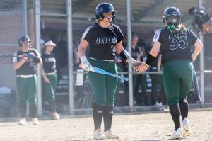 Aliana Langsea high-fives a teammate before stepping up to the plate during a game against Kamiak on Monday, April 20, 2026 in Mill Creek, Washington. (Olivia Vanni / The Herald)
