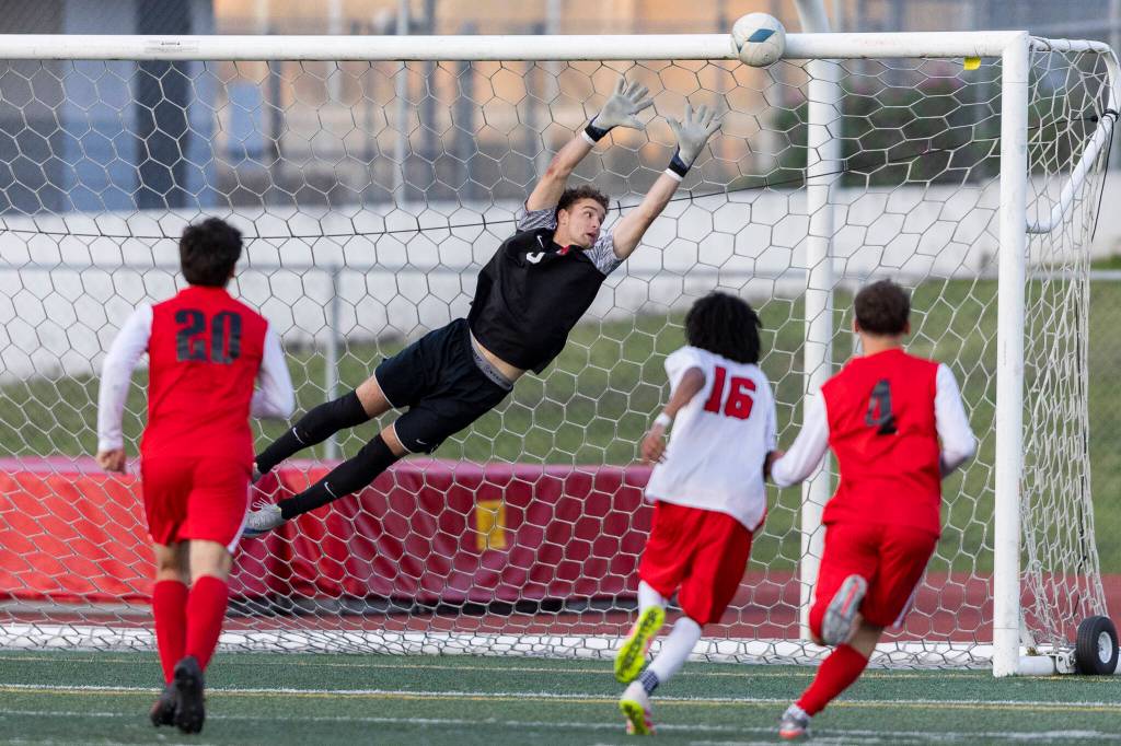 Snohomishs Zachary Khorrami dives for a shot by Mountlake Terraces Ash Jeffers as the ball hits off the crossbar during the second half of the loser-out 3A district playoff game on Thursday, May 7, 2026 in Snohomish, Washington. (Olivia Vanni / The Herald)