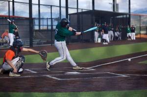 Jackson senior Gavin Clark puts the ball in play during the Timberwolves 5-3 win against Monroe at Monroe High School on April 3, 2026. (Joe Pohoryles / The Herald)