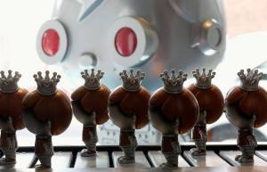 Funko mascots Freddy Funko roll past on a conveyor belt in the Pop! Factory of the companys flagship store on Aug. 18, 2017. (Dan Bates / The Herald)