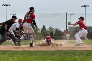 Snohomishs Breckin Davisson slides into home plate during a District 1 3A quarterfinal game against Mountlake Terrace on Saturday, May 9, 2026 at Snohomish H.S. (Qasim Ali / The Herald)