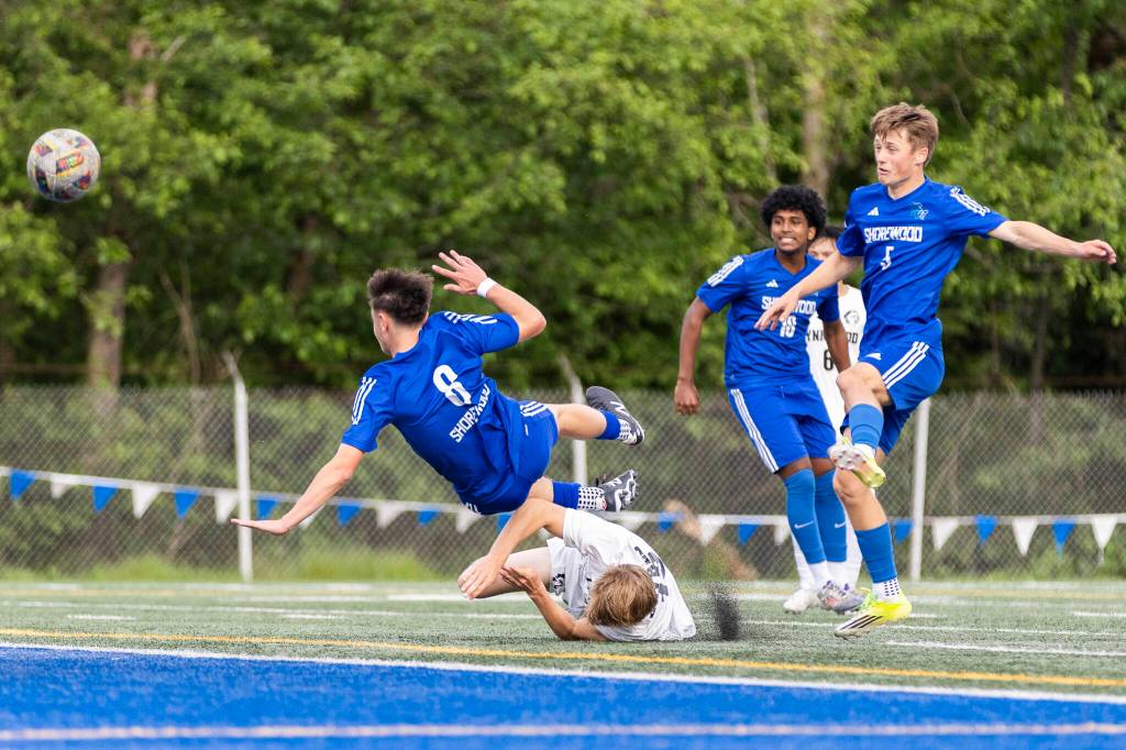 Shorewoods Isak Medhaug leaps over Lynnwoods Brandon Miller as Shorewoods Bobby Lamb takes a shot during the 3A district semifinal game on Tuesday, May 12, 2026 in Shoreline, Washington. (Olivia Vanni / The Herald)
