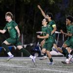 Shorecrests Kai Short and teammates run toward Shorecrests Maceo Jala after he scores the winning penalty kick to beat Edmonds-Woodway in the 3A district semifinal game on Tuesday, May 12, 2026 in Shoreline, Washington. (Olivia Vanni / The Herald)