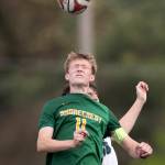 Shorecrests Ashton Johnson jumps up to head the ball during the 3A district semifinal game on Tuesday, May 12, 2026 in Shoreline, Washington. (Olivia Vanni / The Herald)