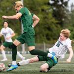 Edmonds-Woodways Jonah Sutcliffe slide tackles Shorecrests Cole Ambrose during the 3A district semifinal game on Tuesday, May 12, 2026 in Shoreline, Washington. (Olivia Vanni / The Herald)