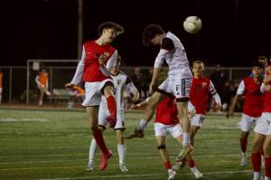 Snohomish junior Paul Joplin (left) heads the ball past a jumping Monroe defender in the Panthers 4-1 loss at Veterans Memorial Stadium in Snohomish, Washington on April 4, 2025. (Joe Pohoryles / The Herald)