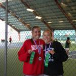 Stanwoods Addison Bowie (left) and Mylee LaComb (right) pose with their medals and ribbons after winning the District 1 3A doubles title on Wednesday, May 13, 2026 at Skagit Valley College in Mount Vernon. (Qasim Ali / The Herald)