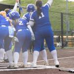 Sedro-Woolleys Veanna Lanphere runs toward her teammates surrounding home plate after hitting a home run during the 3A district championship game against Everett on Thursday, May 14, 2026 in Everett, Washington. (Olivia Vanni / The Herald)