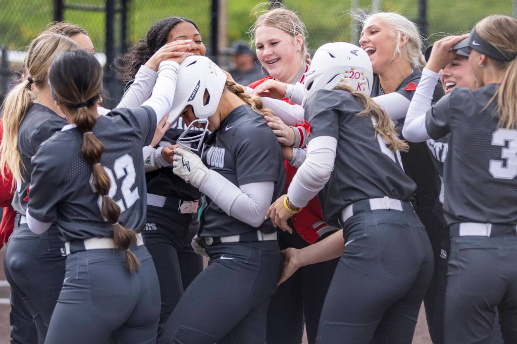Stanwoods Jordan Rancourt celebrates her home run with her teammates during the 3A district loser-out game against Meadowdale on Thursday, May 14, 2026 in Everett, Washington. (Olivia Vanni / The Herald)
