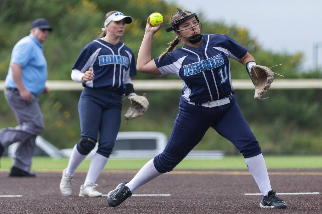 Meadowdales Lillian McCormick throws the ball to first base during the 3A district loser-out game against Stanwood on Thursday, May 14, 2026 in Everett, Washington. (Olivia Vanni / The Herald)