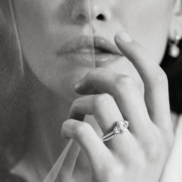 bride with diamond eternity wedding band and three stone engagement ring